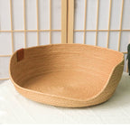 Round woven dog bed with a low front entry