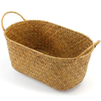 Low oval woven basket with braided handles