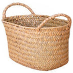 Low oval woven basket with braided handles