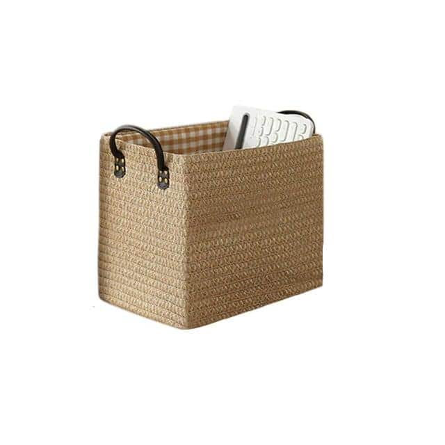 Woven storage boxes with leather look handles on a shelf