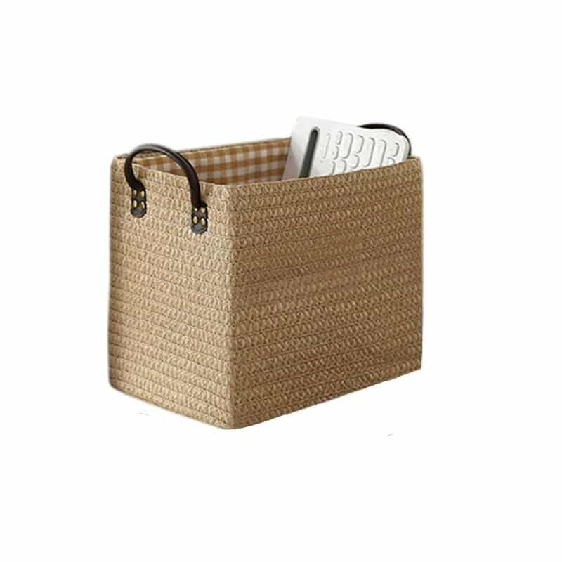 Woven storage boxes with leather look handles on a shelf