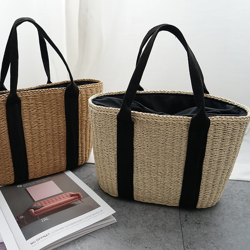 Tightly woven straw handbag with an adjustable strap and inner phone pocket