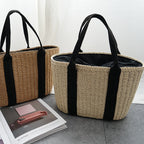 Tightly woven straw handbag with an adjustable strap and inner phone pocket