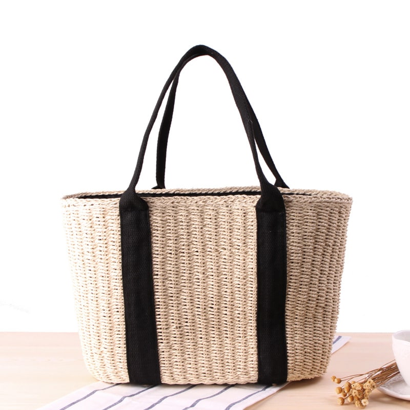 Tightly woven straw handbag with an adjustable strap and inner phone pocket