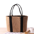 Tightly woven straw handbag with an adjustable strap and inner phone pocket