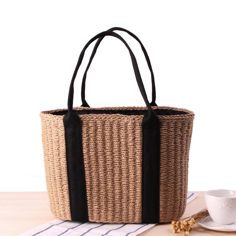 Tightly woven straw handbag with an adjustable strap and inner phone pocket