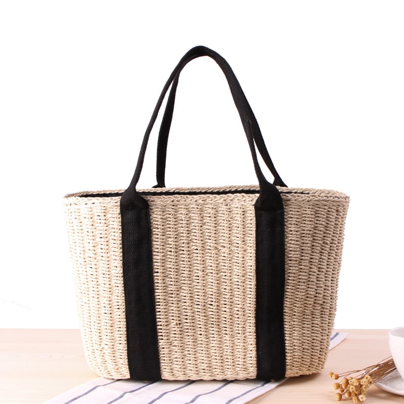 Tightly woven straw handbag with an adjustable strap and inner phone pocket