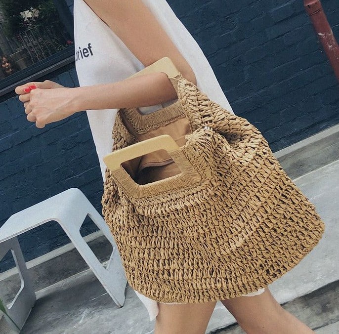 Woven straw tote bag with varnished wooden handles in beige or brown