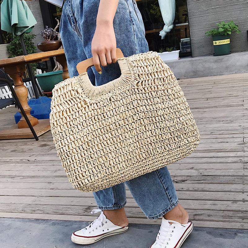 Woven straw tote bag with varnished wooden handles in beige or brown