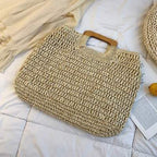 Woven straw tote bag with varnished wooden handles in beige or brown