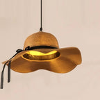 Pendant light shaped like a woven sun hat with black ribbon