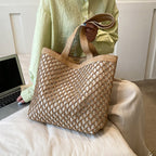 Structured woven tote bag with a top zip closure in blue or beige
