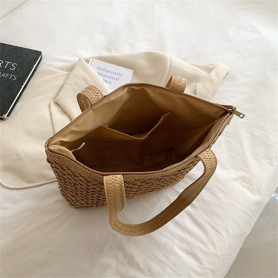 Structured woven tote bag with a top zip closure in blue or beige