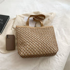 Structured woven tote bag with a top zip closure in blue or beige