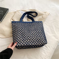 Structured woven tote bag with a top zip closure in blue or beige